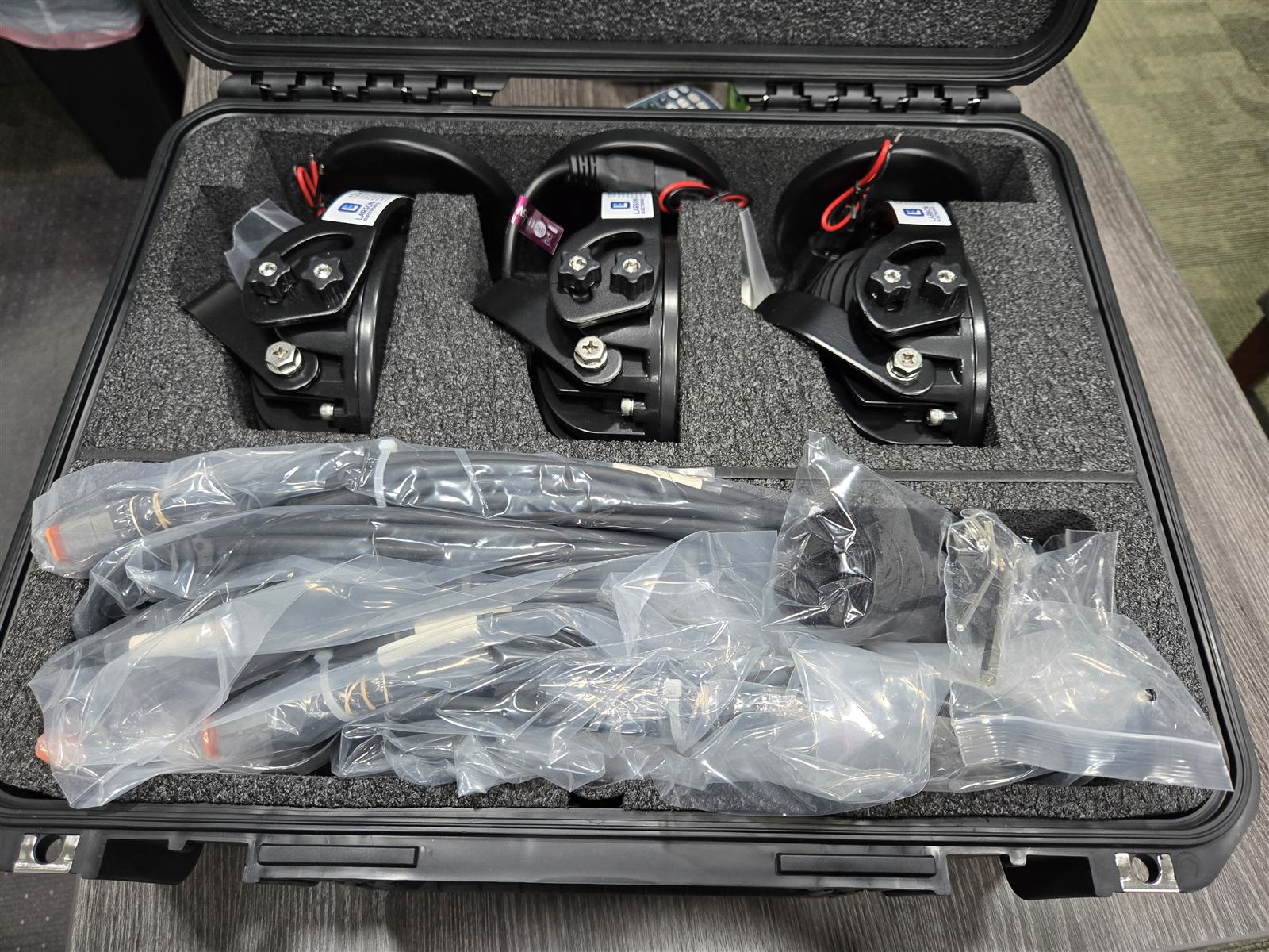 Close-up of a kitted LED work light and mounting hardware