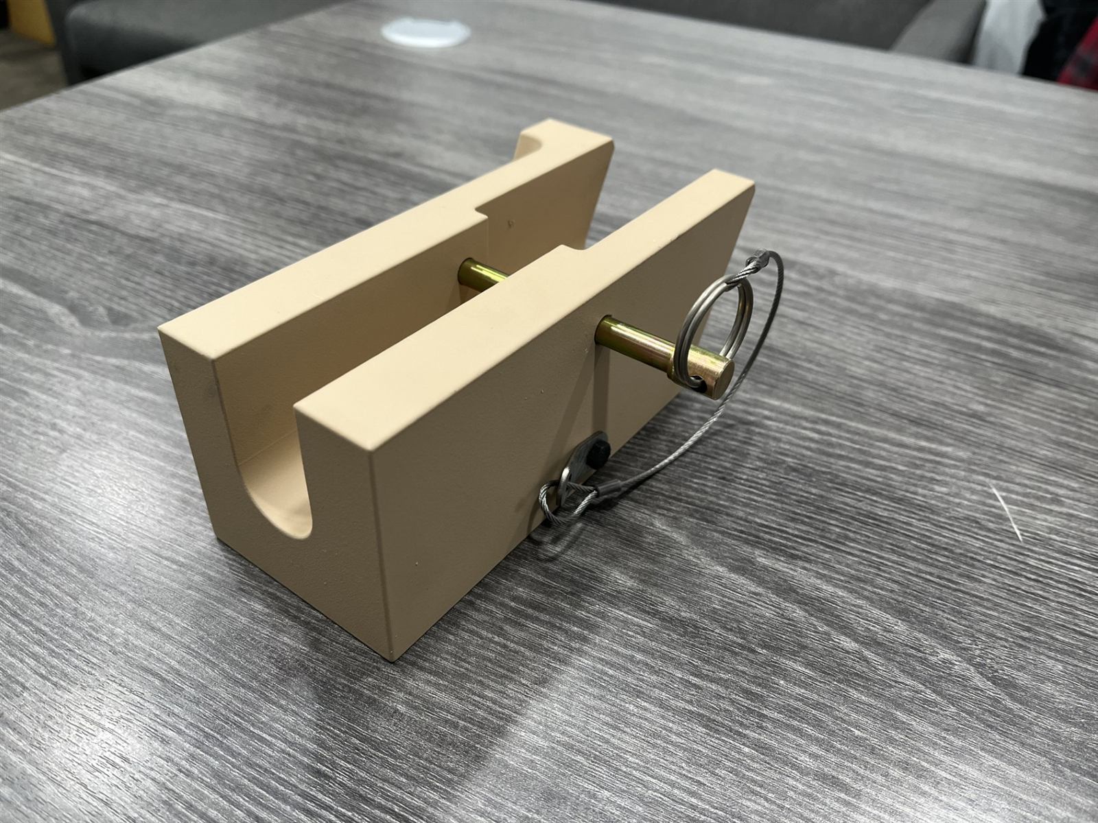 Machined bracket component with safety-wired hardware