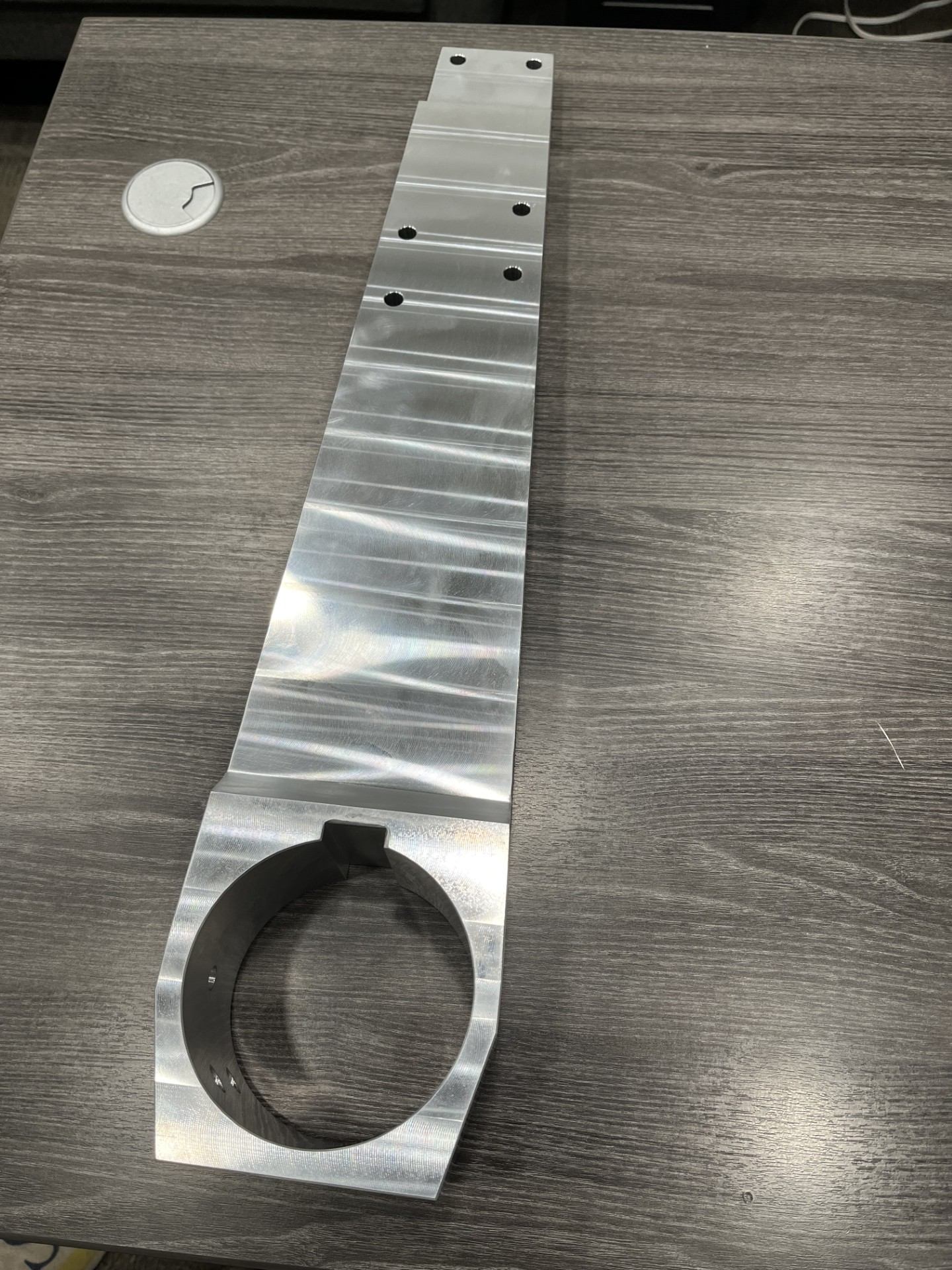 Long precision-machined rail bracket component